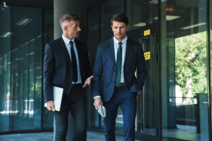 Two investment partners walking outside an office building